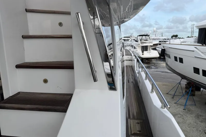 Slide: The Image of Staircase and deck view of 2017 Azimut Fly 72 yacht in marina. - 3