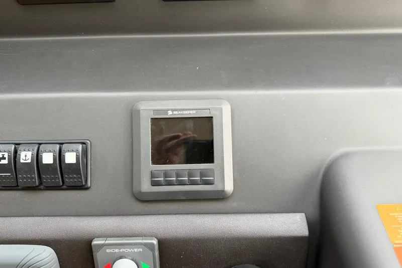 Slide: The Image of Control panel of a 2017 Azimut Fly 72 yacht featuring Seakeeper display and switches. - 32