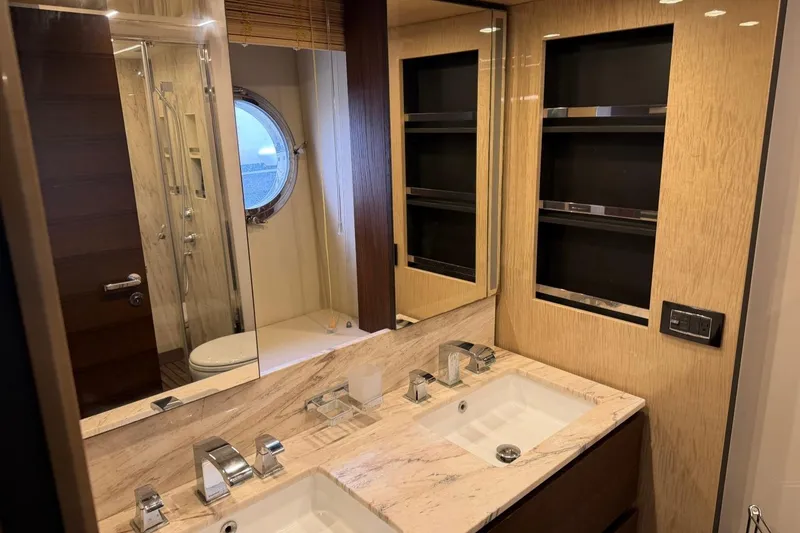 Slide: The Image of Luxurious bathroom interior of 2017 Azimut Fly 72 yacht with dual sinks and porthole window. - 41