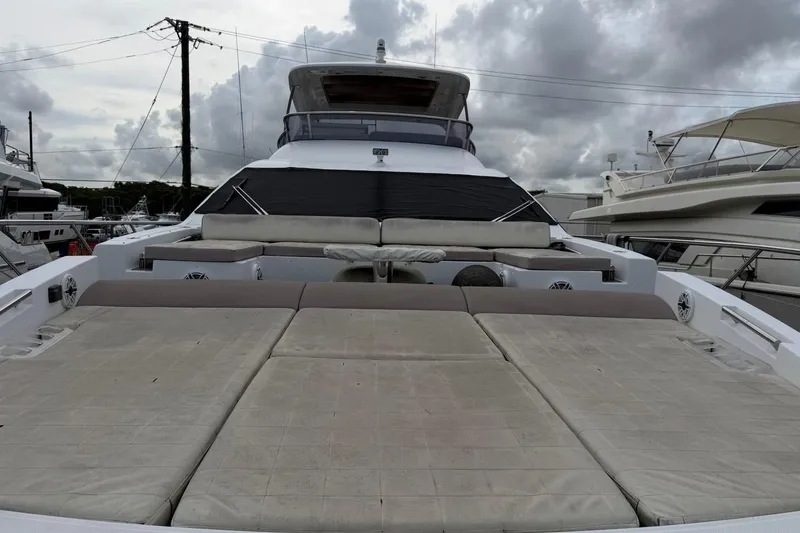 Slide: The Image of 2017 Azimut Fly 72 yacht with spacious deck and seating, under cloudy skies. - 5