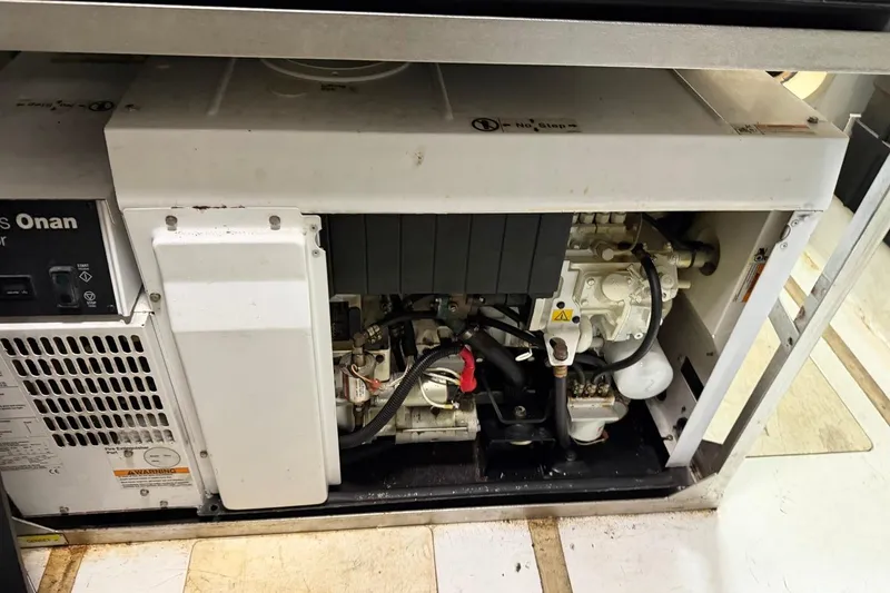 Slide: The Image of Engine compartment of a 2017 Azimut Fly 72 yacht, featuring a Cummins Onan generator. - 61