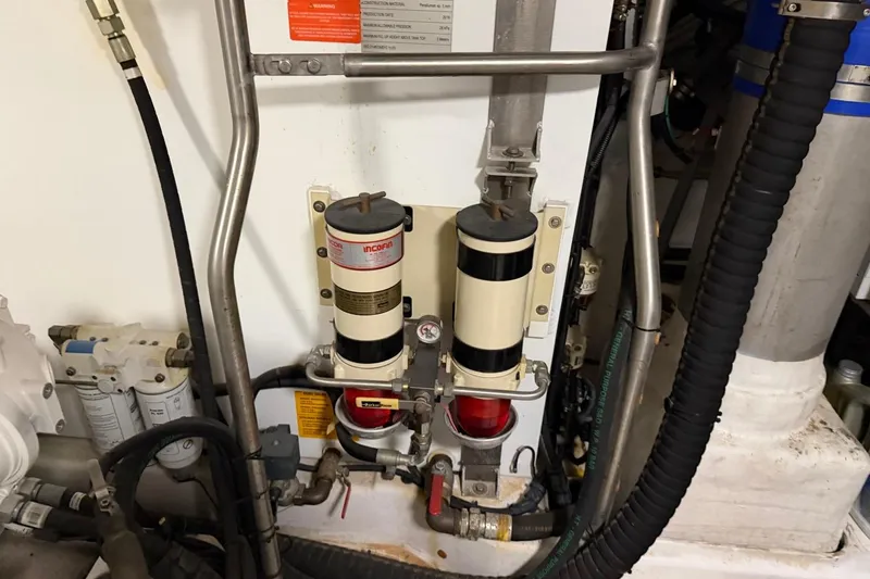 Slide: The Image of Engine room components of a 2017 Azimut Fly 72 yacht, featuring fuel filters and piping. - 63