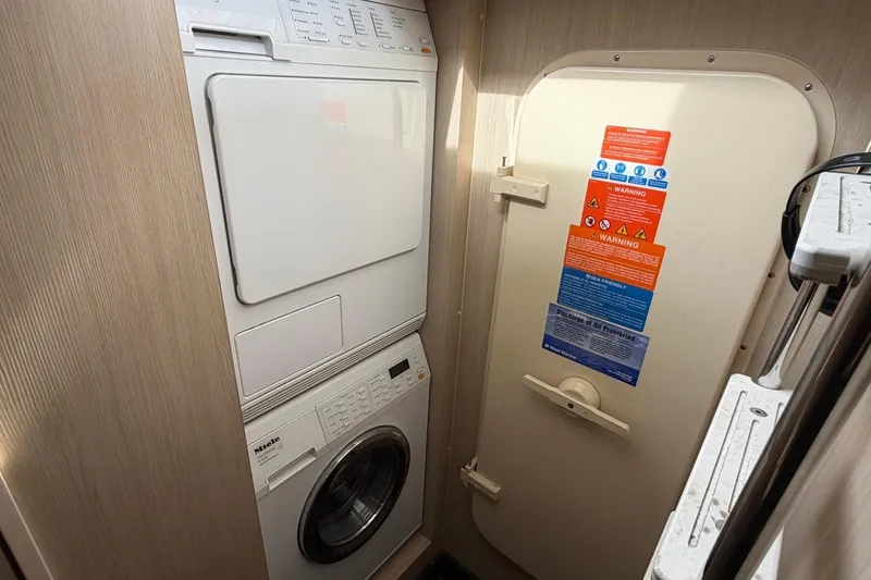 Slide: The Image of Laundry area with stacked washer and dryer in 2017 Azimut Fly 72 yacht. - 72