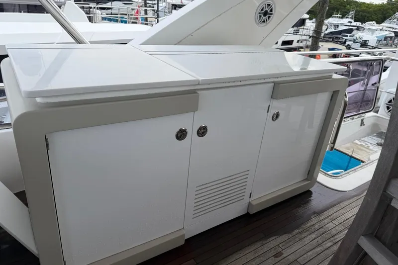 Slide: The Image of Outdoor cabinet on 2017 Azimut Fly 72 yacht deck, featuring sleek white design. - 8