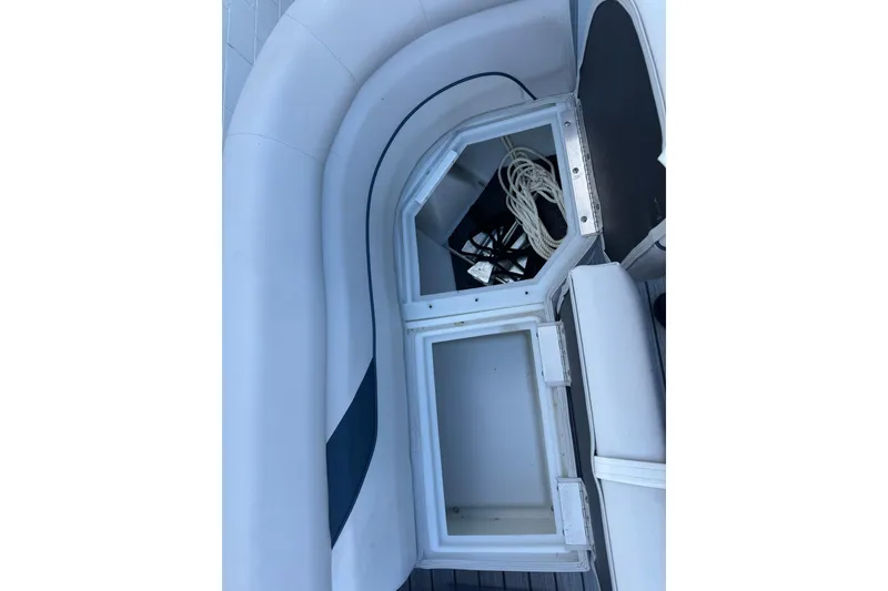 Slide: The Image of 2024 SunCatcher Select 16C boat storage compartments with ropes and equipment. - 10