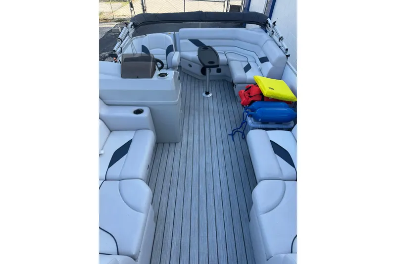 Slide: The Image of 2024 SunCatcher Select 16C pontoon boat interior with gray seating and accessories. - 6