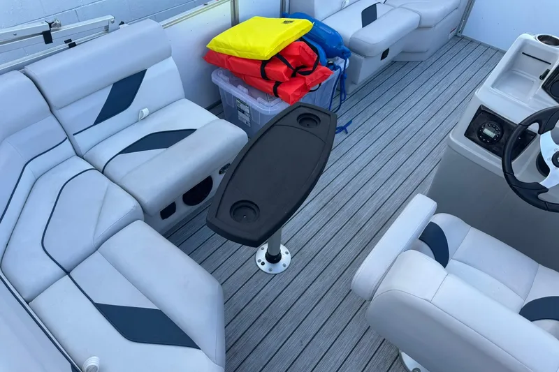 Slide: The Image of 2024 SunCatcher Select 16C boat interior with seating, table, and life jackets. - 9