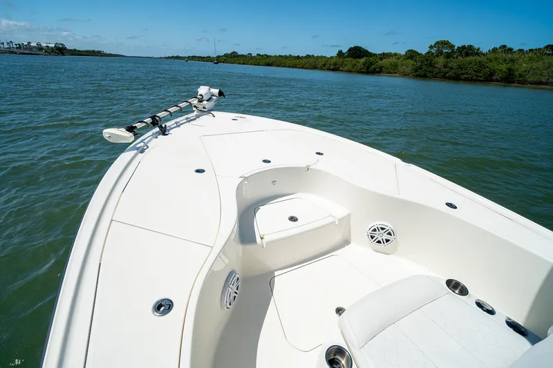 Slide: The Image of 2018 SeaVee 270Z boat on calm water, featuring spacious deck and seating. - 12