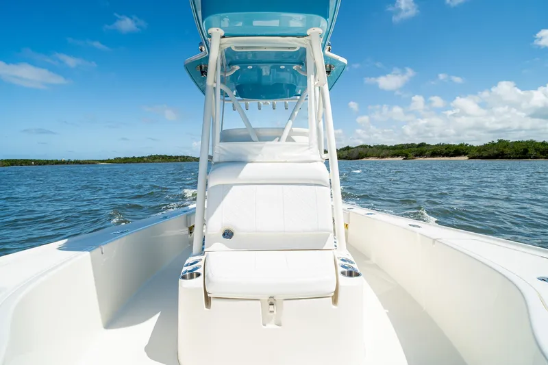 Slide: The Image of 2018 SeaVee 270Z boat cruising on open water under a clear blue sky. - 19