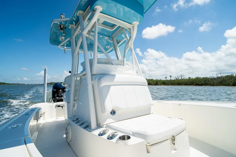 Slide: The Image of 2018 SeaVee 270Z boat on water, clear sky, and lush shoreline in background. - 20