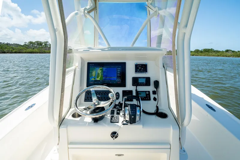 Slide: The Image of 2018 SeaVee 270Z boat console with navigation equipment on calm water. - 26