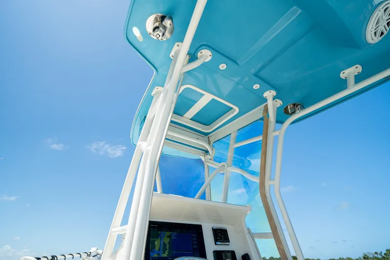Slide: The Image of 2018 SeaVee 270Z boat console with blue canopy against clear sky. - 28
