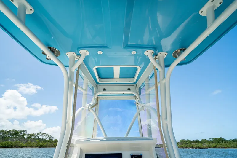 Slide: The Image of 2018 SeaVee 270Z boat interior with blue canopy and clear skies. - 29