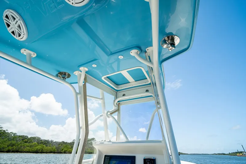 Slide: The Image of 2018 SeaVee 270Z boat interior with blue canopy and clear sky background. - 30