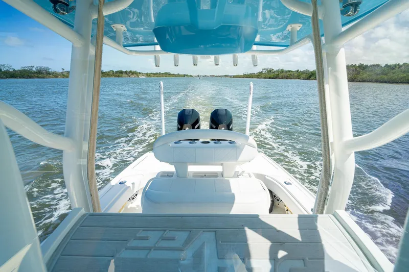 Slide: The Image of 2018 SeaVee 270Z boat cruising on a scenic waterway, showcasing dual engines and sleek design. - 33
