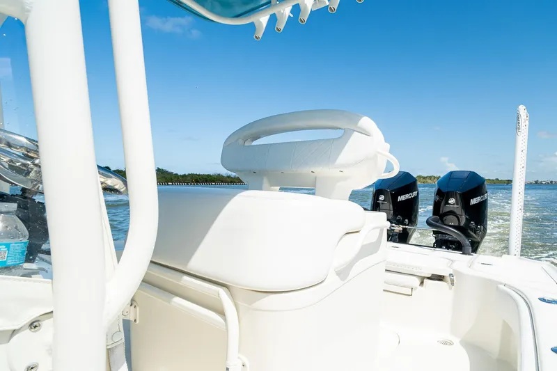Slide: The Image of 2018 SeaVee 270Z boat interior with dual Mercury engines on a sunny day. - 34
