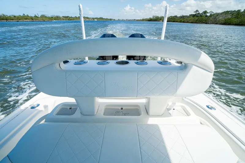 Slide: The Image of 2018 SeaVee 270Z boat interior with white seating, cruising on open water. - 35