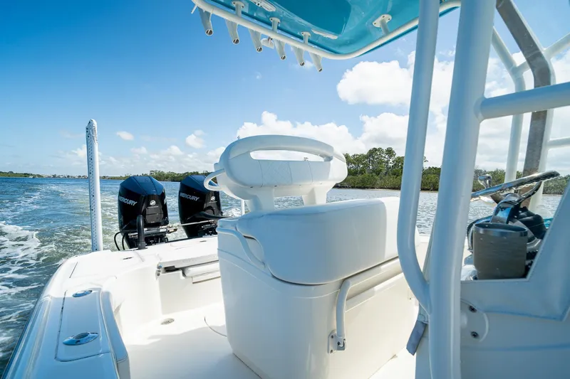 Slide: The Image of 2018 SeaVee 270Z boat interior with dual Mercury engines on a sunny day. - 36