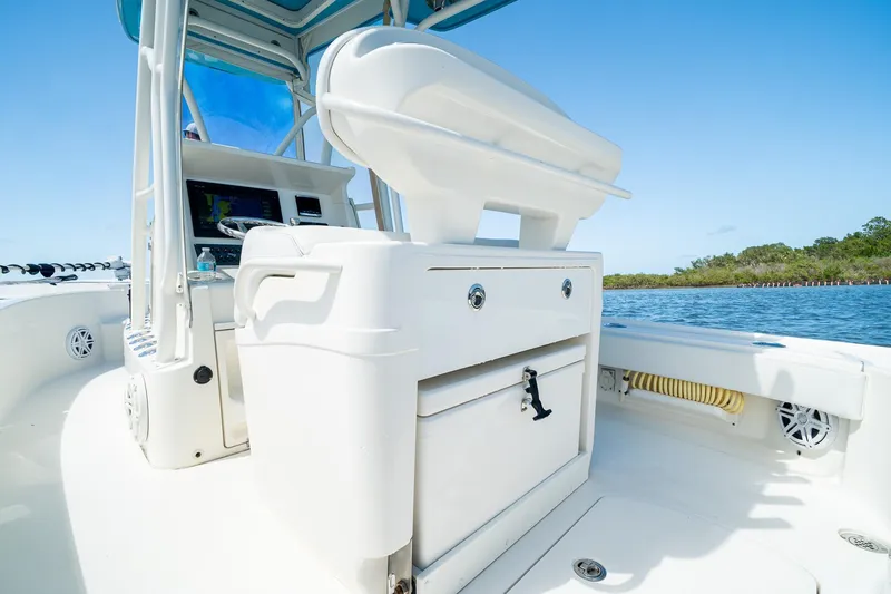 Slide: The Image of 2018 SeaVee 270Z boat interior with console and seating, on a sunny day by the water. - 39