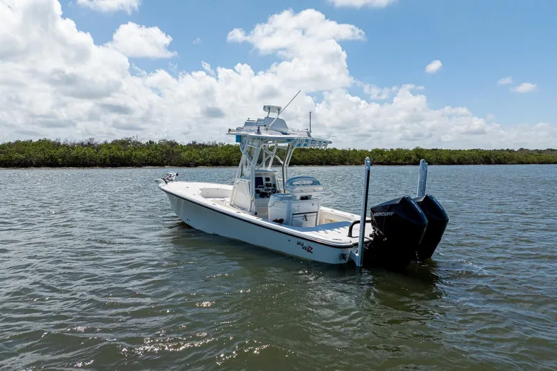 Slide: The Image of 2018 SeaVee 270Z boat on calm water under a partly cloudy sky. - 4