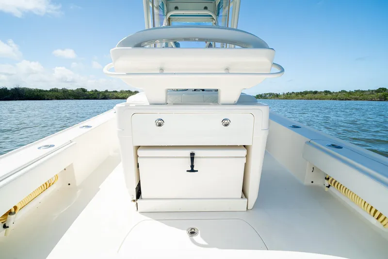 Slide: The Image of 2018 SeaVee 270Z boat interior with storage compartment, on calm water under blue sky. - 41