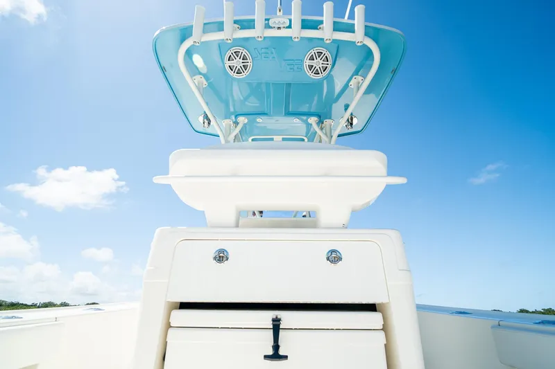 Slide: The Image of 2018 SeaVee 270Z boat with blue canopy and speakers against clear sky. - 42