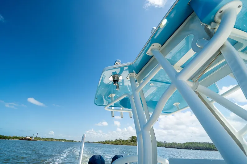 Slide: The Image of 2018 SeaVee 270Z boat on water, showcasing blue canopy and clear sky. - 45