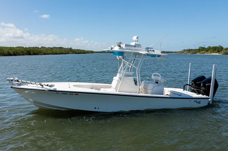 Slide: The Image of 2018 SeaVee 270Z boat on calm water under clear blue sky. - 5