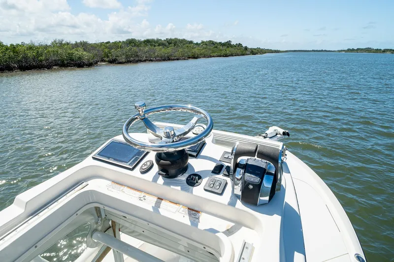 Slide: The Image of 2018 SeaVee 270Z boat helm with steering wheel and controls on open water. - 50