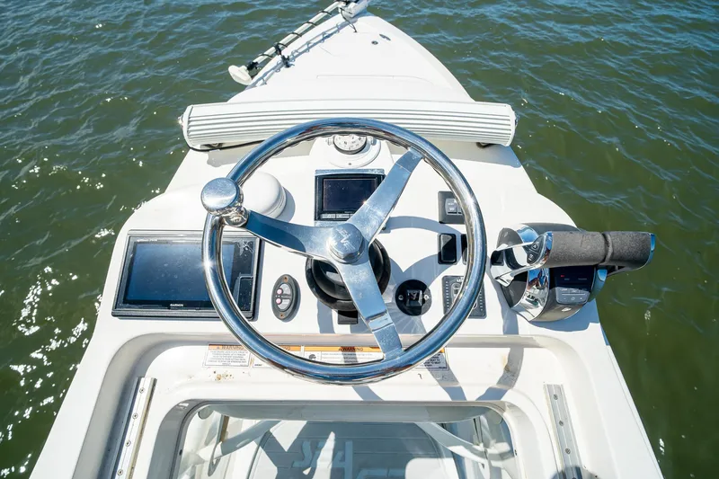 Slide: The Image of 2018 SeaVee 270Z boat helm with steering wheel and navigation controls. - 51