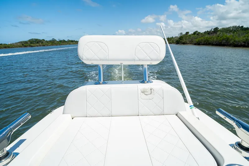 Slide: The Image of 2018 SeaVee 270Z boat cruising on a sunny day, featuring white seating and calm waters. - 52