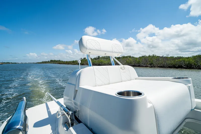Slide: The Image of 2018 SeaVee 270Z boat cruising on a sunny day, featuring sleek white seating. - 53
