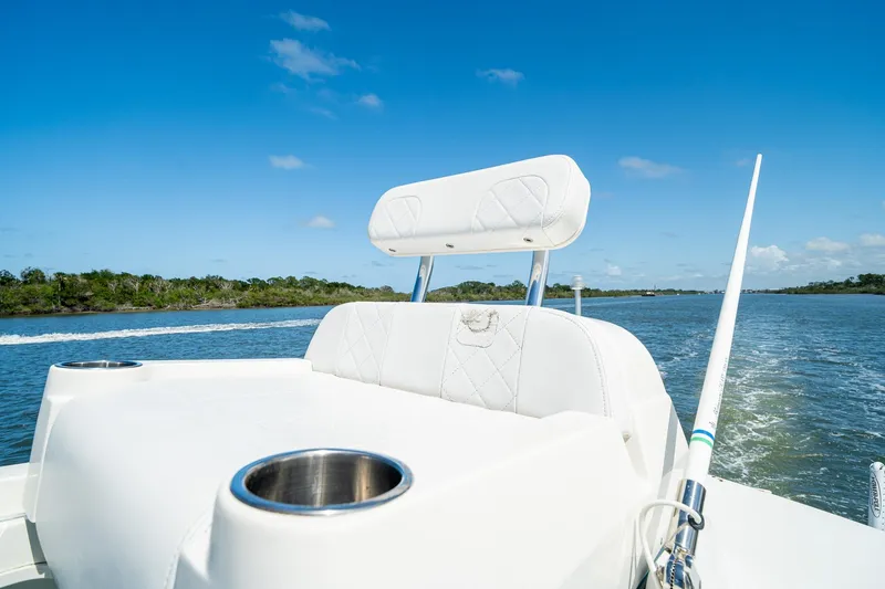Slide: The Image of 2018 SeaVee 270Z boat cruising on a sunny day, featuring white seating and cup holders. - 54