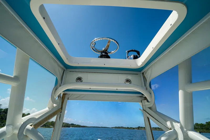 Slide: The Image of View from a 2018 SeaVee 270Z boat's helm, showcasing clear blue skies and water. - 55