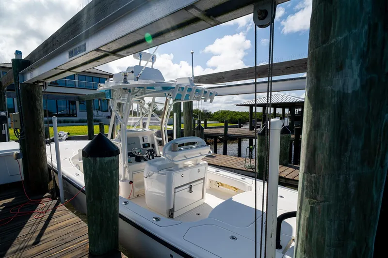 Slide: The Image of 2018 SeaVee 270Z boat docked at a marina under a clear sky. - 59
