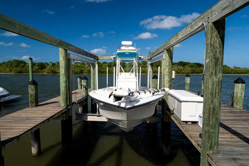 Slide: The Image of 2018 SeaVee 270Z boat docked on a wooden pier under a clear blue sky. - 60