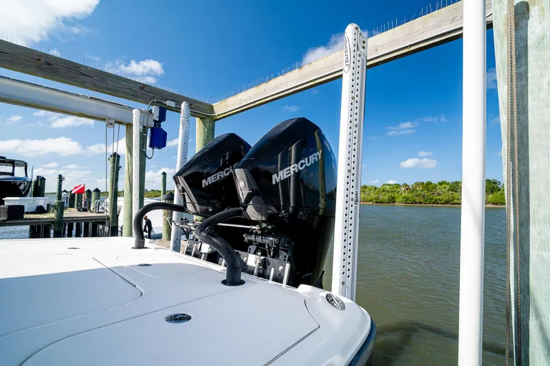 Slide: The Image of 2018 SeaVee 270Z boat with dual Mercury engines docked by the water. - 64