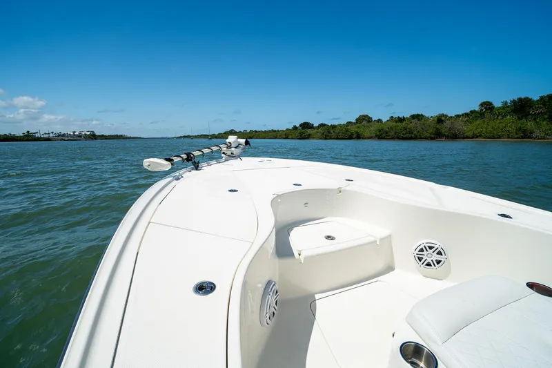 Slide: The Image of 2018 SeaVee 270Z boat cruising on a sunny day, surrounded by calm waters and lush greenery. - 8