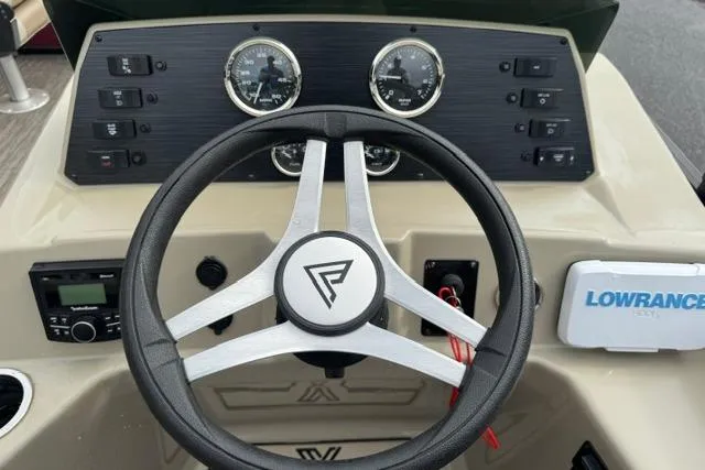 Slide: The Image of 2022 Viaggio Lago 18F boat dashboard with steering wheel and control panel. - 11