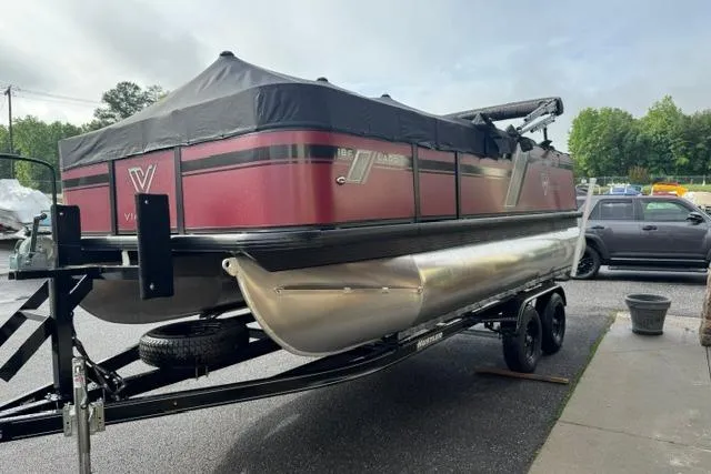 Slide: The Image of 2022 Viaggio Lago 18F pontoon boat on trailer, parked outdoors. - 2