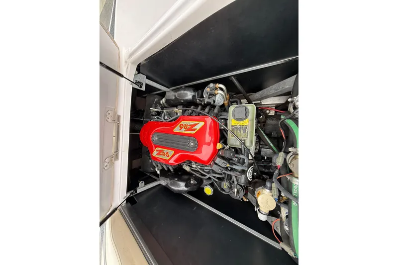Slide: The Image of Engine of 2006 Nautique Super Air Nautique 220 with red cover, detailed view. - 2