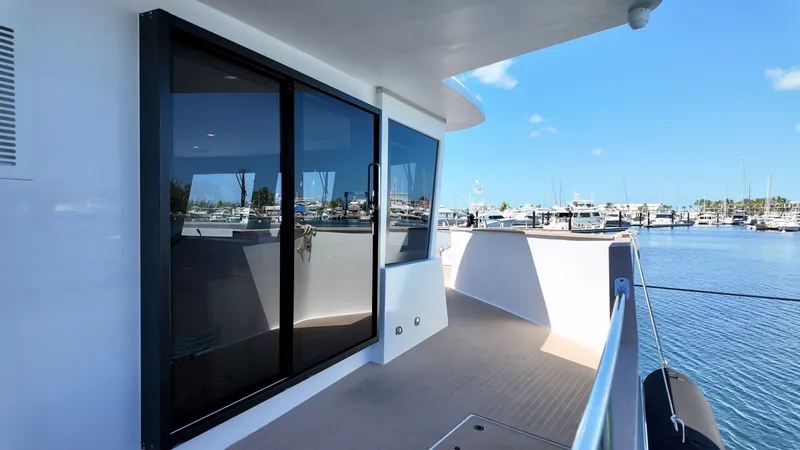 Slide: The Image of LEEN-TRIMARANS 72, 2024, modern deck design in harbor. - 16