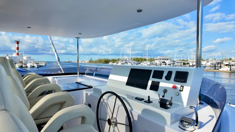 Slide: The Image of LEEN-TRIMARANS 72, 2024, helm station with harbor view and lighthouse. - 7