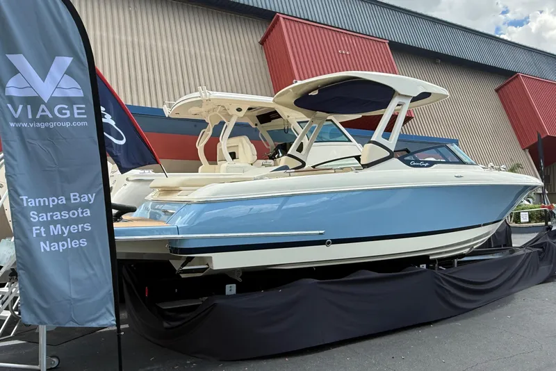 Slide: The Image of 2026 Chris-Craft Sportster 28 boat displayed at Viage Group, featuring sleek blue and white design. - 2