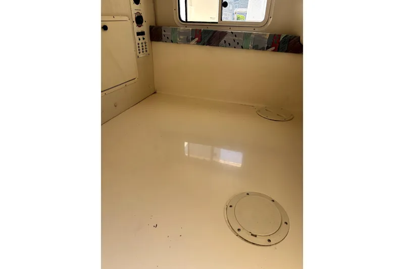 Slide: The Image of Interior cabin of a 1997 Donzi 255 LXC boat, featuring a clean, beige surface. - 10