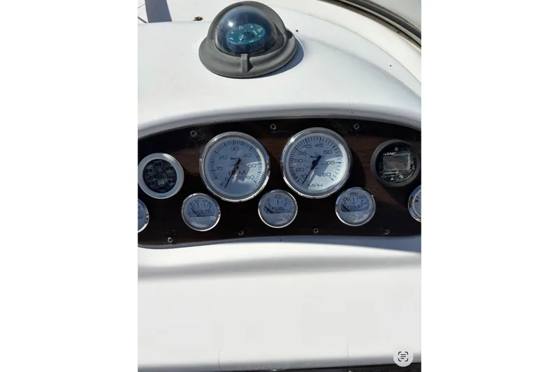 Slide: The Image of Dashboard of a 1997 Donzi 255 LXC boat with gauges and compass. - 11