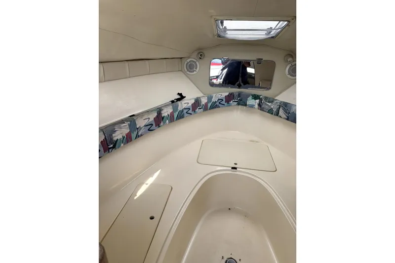 Slide: The Image of Interior of a 1997 Donzi 255 LXC boat cabin with seating and storage. - 7