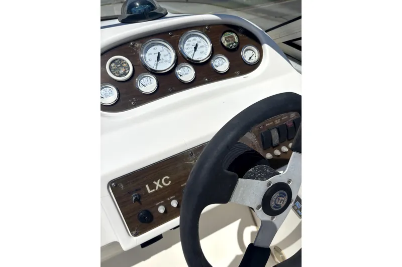 Slide: The Image of 1997 Donzi 255 LXC boat dashboard with gauges and steering wheel. - 8