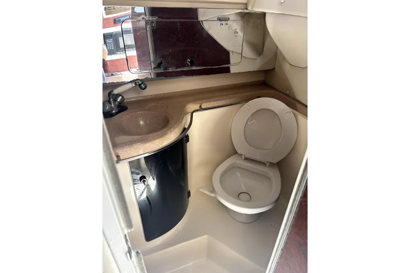 Slide: The Image of Bathroom interior of a 1997 Donzi 255 LXC boat with sink and toilet. - 9