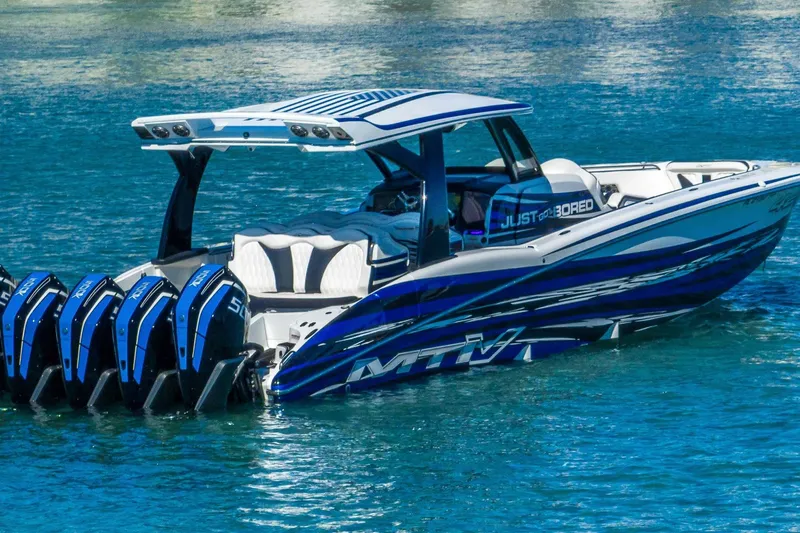 The Image of 2024 MTI V42 boat with multiple engines on clear blue water. - 0